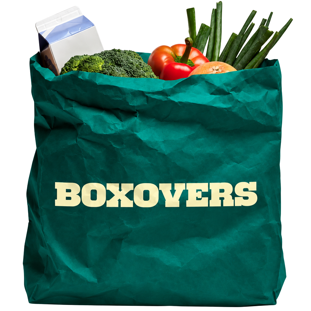 A crumpled dark teal BOXOVERS paper bag filled with fresh vegetables and groceries